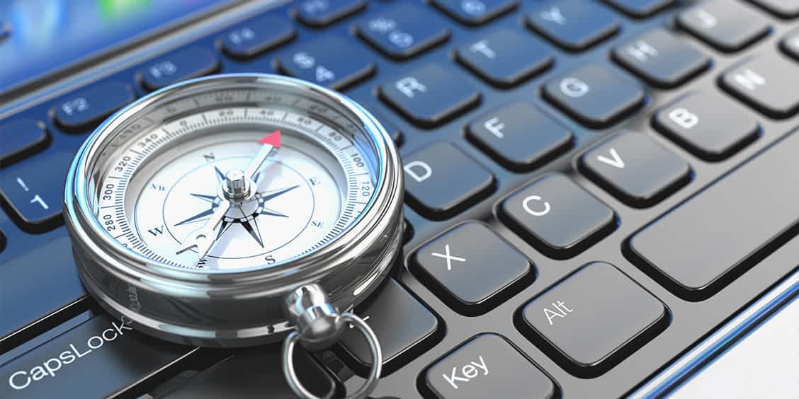 The compass on a keyboard representing business IT support