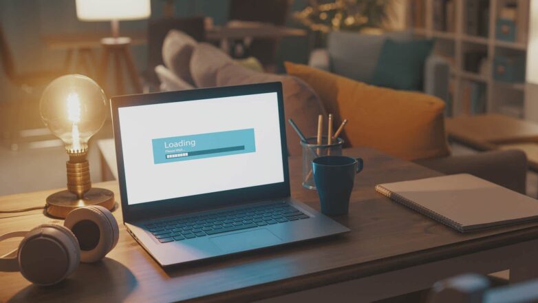 Laptop with loading screen symbolizing slow performance for blog post 'How to Speed Up a Slow Computer' by Express PC Pro